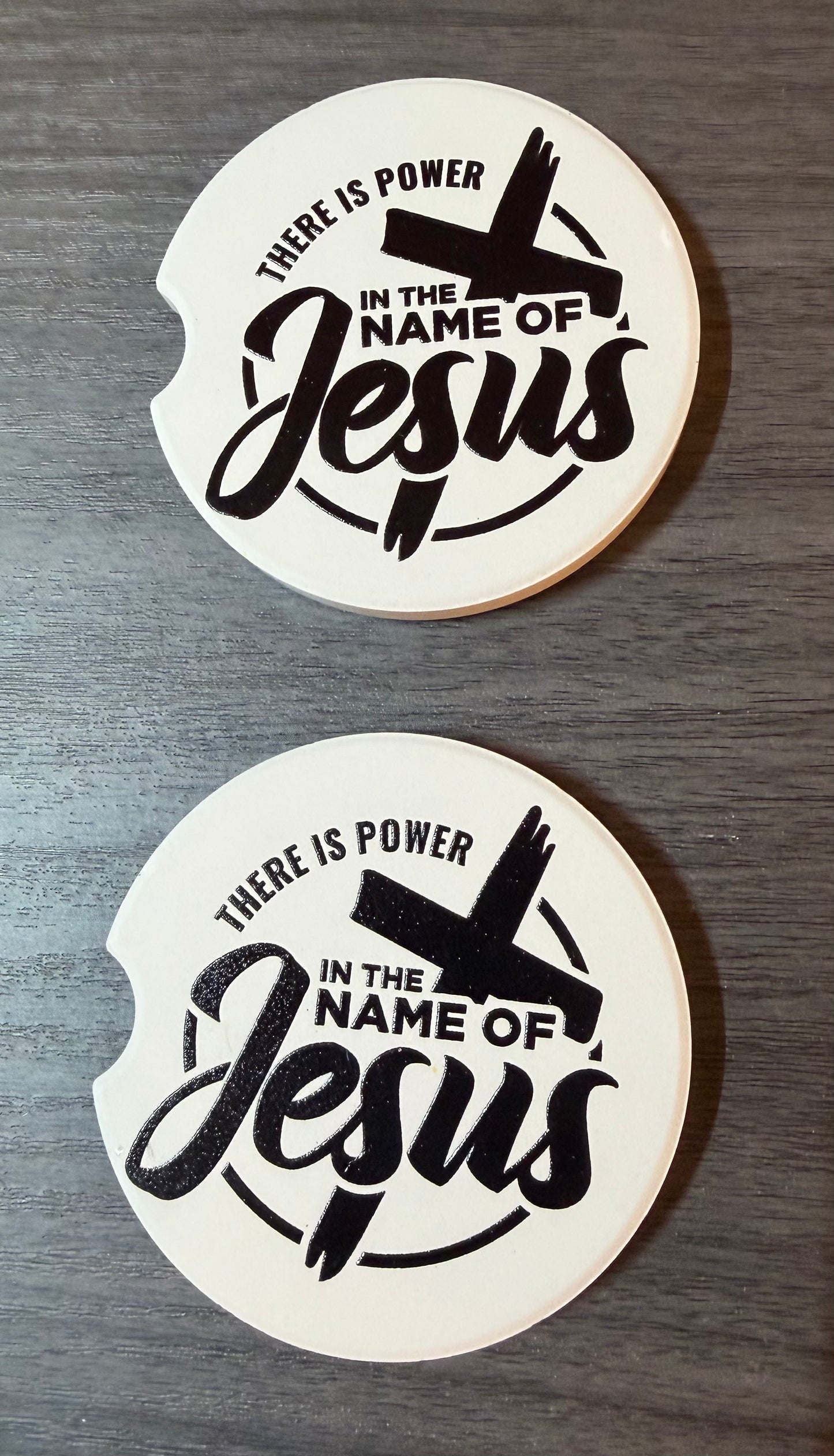 "In The Name Of Jesus" Ceramic car coasters, designed to fit most cup holders, are absorbent and help keep cars clean. They feature a vibrant design and are a great gift for car lovers.