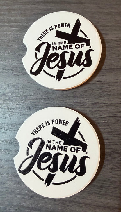 "In The Name Of Jesus" Ceramic car coasters, designed to fit most cup holders, are absorbent and help keep cars clean. They feature a vibrant design and are a great gift for car lovers.