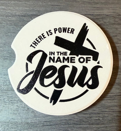 "In The Name Of Jesus" Ceramic car coasters, designed to fit most cup holders, are absorbent and help keep cars clean. They feature a vibrant design and are a great gift for car lovers.