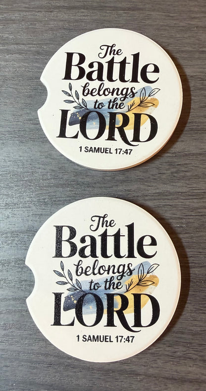 "The Battle Belongs to the Lord" Ceramic car coasters, designed to fit most cup holders, are absorbent and help keep cars clean. They feature a vibrant design and are a great gift for car lovers.