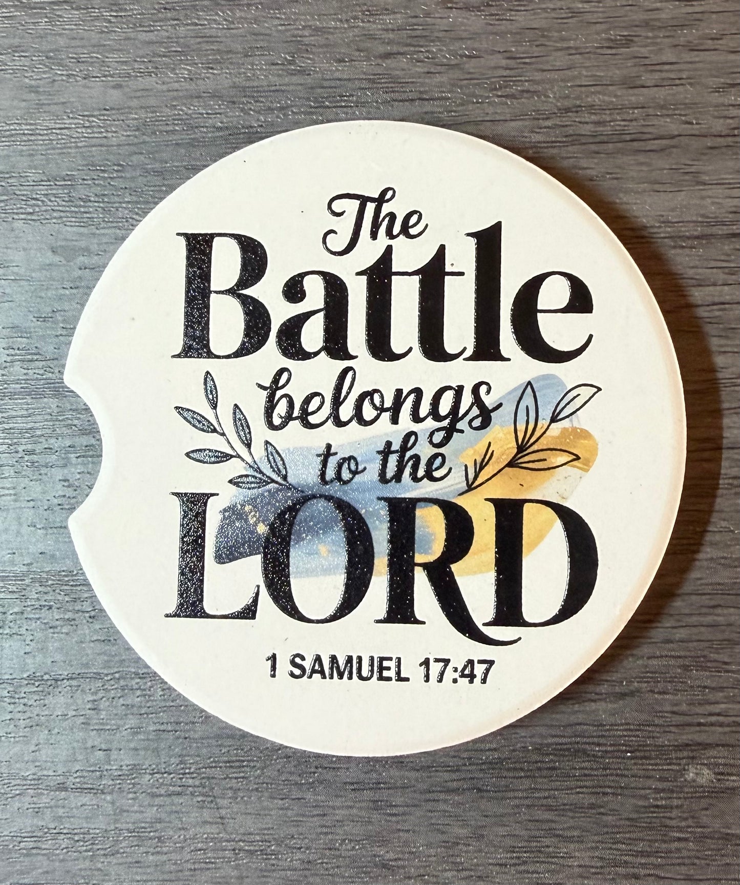 "The Battle Belongs to the Lord" Ceramic car coasters, designed to fit most cup holders, are absorbent and help keep cars clean. They feature a vibrant design and are a great gift for car lovers.