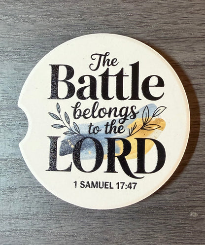 "The Battle Belongs to the Lord" Ceramic car coasters, designed to fit most cup holders, are absorbent and help keep cars clean. They feature a vibrant design and are a great gift for car lovers.