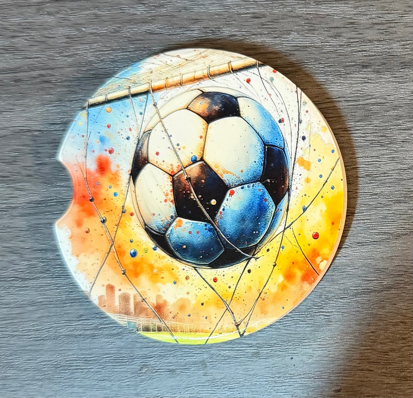 Soccer Sporting Ceramic car coasters, designed to fit most cup holders, are absorbent and help keep cars clean. They feature a vibrant design and are a great gift for car lovers.
