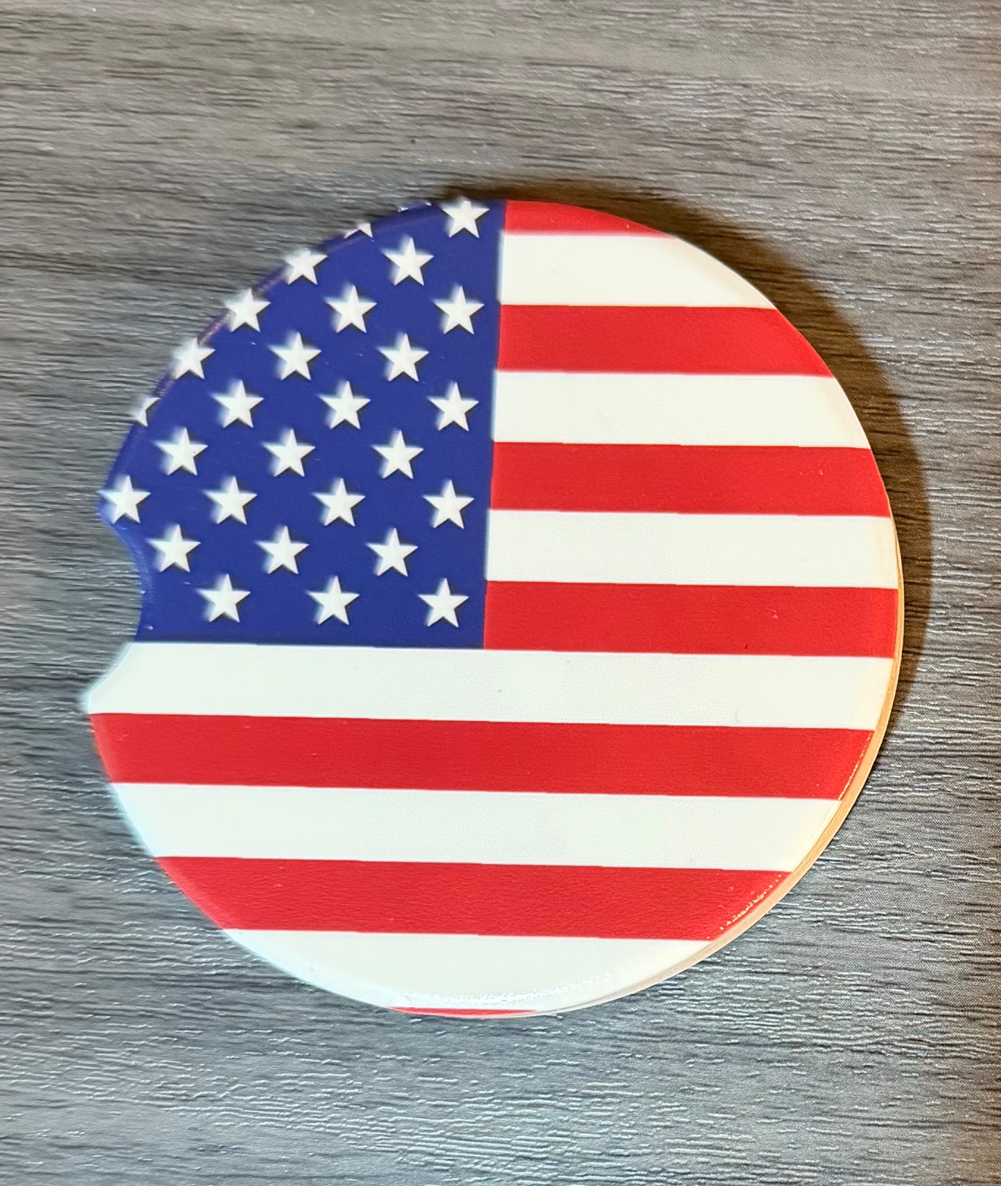 USA Flag Ceramic car coasters, designed to fit most cup holders, are absorbent and help keep cars clean. They feature a vibrant design and are a great gift for car lovers.