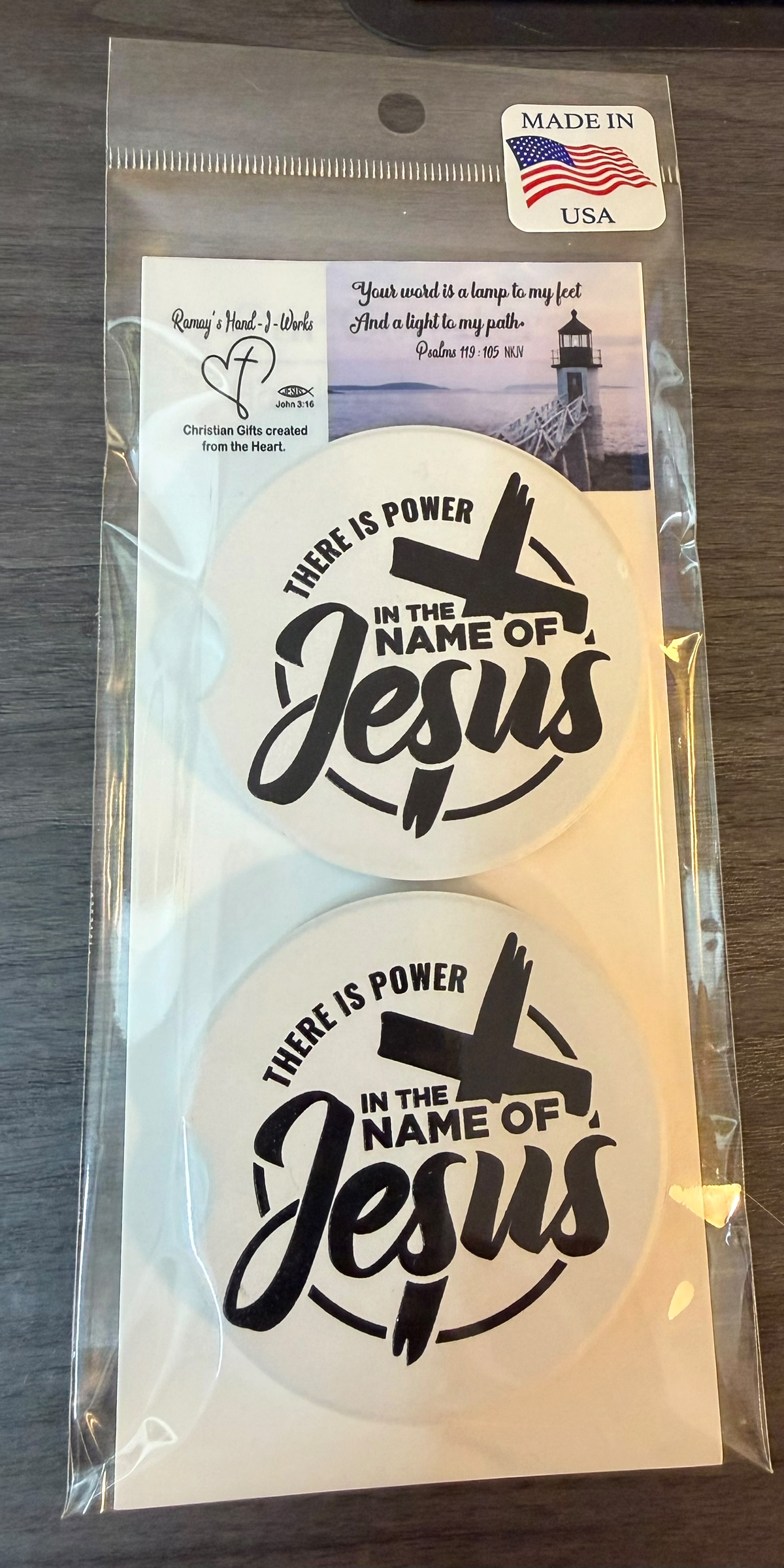 "In The Name Of Jesus" Ceramic car coasters, designed to fit most cup holders, are absorbent and help keep cars clean. They feature a vibrant design and are a great gift for car lovers.