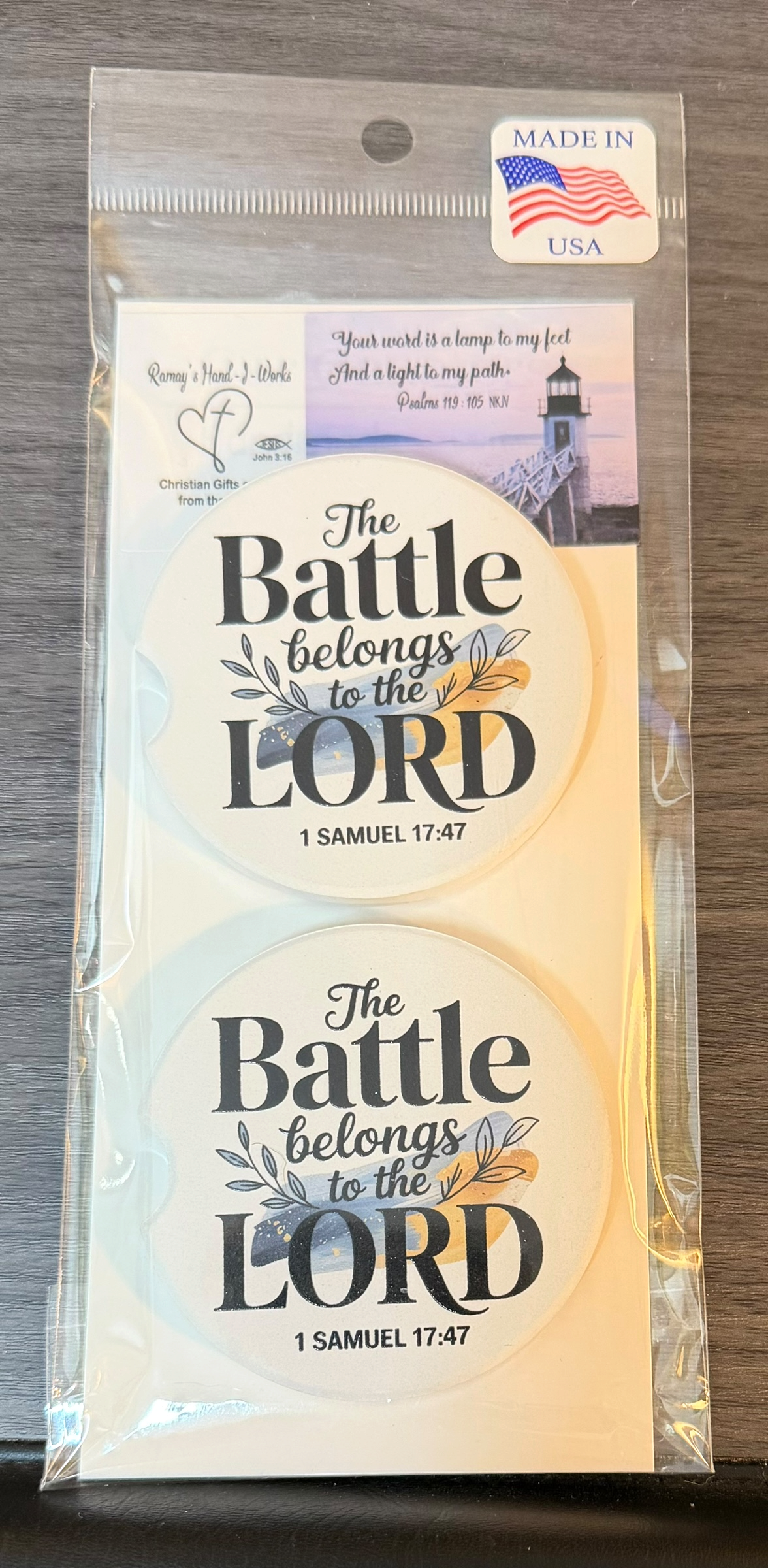 "The Battle Belongs to the Lord" Ceramic car coasters, designed to fit most cup holders, are absorbent and help keep cars clean. They feature a vibrant design and are a great gift for car lovers.