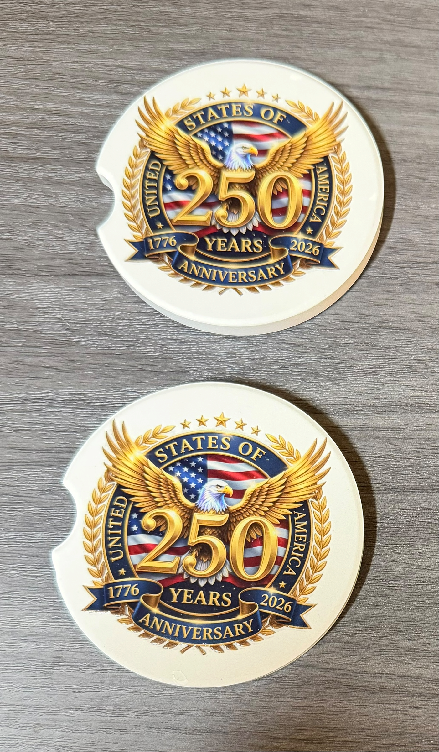 250th USA Anniversary 2B Ceramic car coasters, designed to fit most cup holders, are absorbent and help keep cars clean. They feature a vibrant design and are a great gift for car lovers.